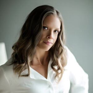 Dr. Chantea Goetz, Performance Psychologist, confidently posing in a white blouse with soft curls, offering mindset mastery and mental performance psychology in Colts Neck, NJ